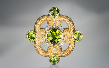 Five Peridot stones designed in a brooch/pendant