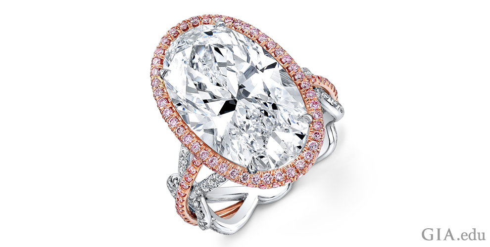 A 10.92 carat (ct) oval diamond engagement ring accented with fancy pink and white melee set in 18K rose gold and platinum