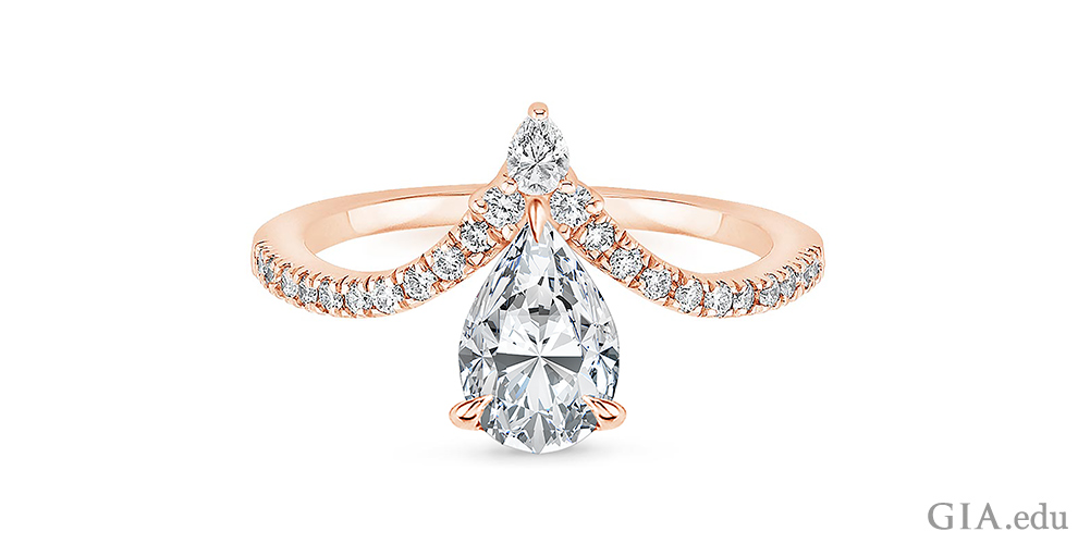 Chevron style pear shaped diamond engagement ring with melee diamonds lining the band.